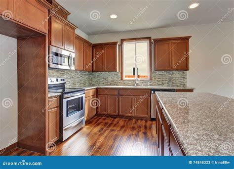 Modern Kitchen Room With Brown Cabinets Granite Counter Tops And