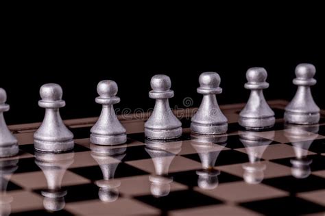 Collection Of Chess Pieces In Silver On A Black Background Photos