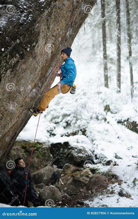 Outdoor Winter Sport Rock Climber Ascending A Challenging Cliff