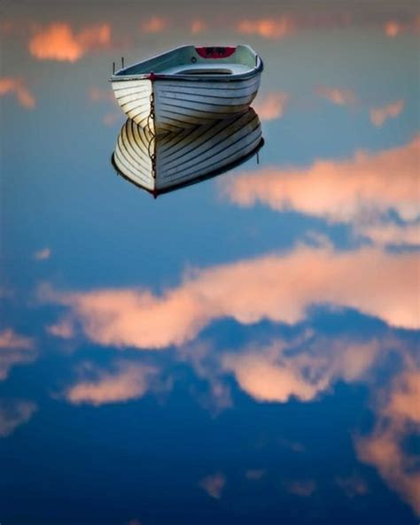 Reflection Of Water Makes The Boat Look Like Its Floating