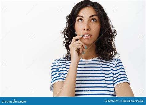 Portrait Of Thoughtful Brunette Girl Looking Up Thinking And Making
