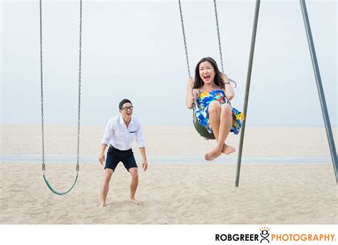 Fun Couple On Swings Near Santa Monica Pier Houston Engagement Session Photographs Best