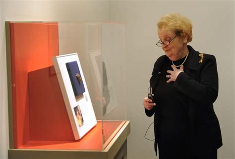 former secretary of state madeleine albright peruses an exhibition of pins from her jewelry