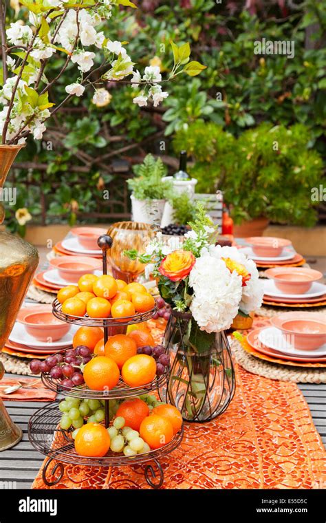 Brunch Table Setting With Oranges And Grapes In The Foreground And
