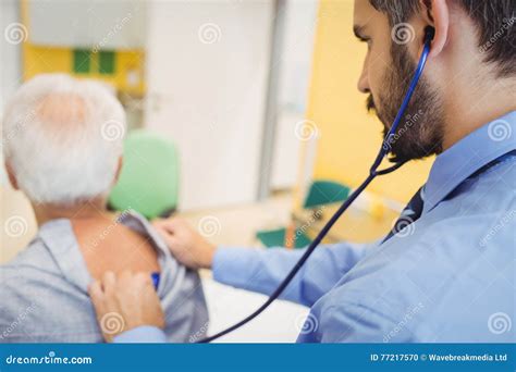 Male Doctor Examining A Patient Stock Photo Image Of Holding Office