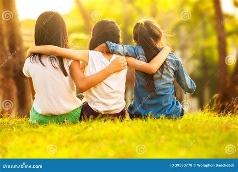 Back View Of Cute Girls Seated On Green Stock Photo Image Of Friends