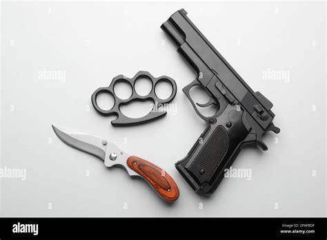 Black Brass Knuckles Gun And Knife On White Background Flat Lay Stock