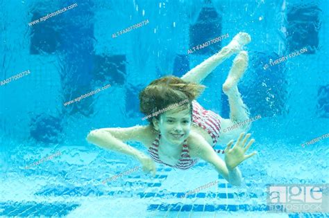 Girl Swimming Underwater In Swimming Pool Stock Photo Picture And