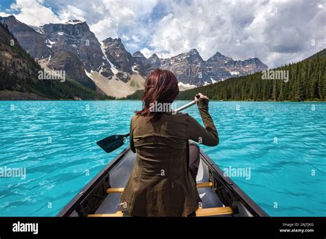 Female Tourist Canoeing On Moraine Lake In Banff National Park
