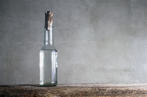 White Vinegar Bottle On Wood Table Premium Photo