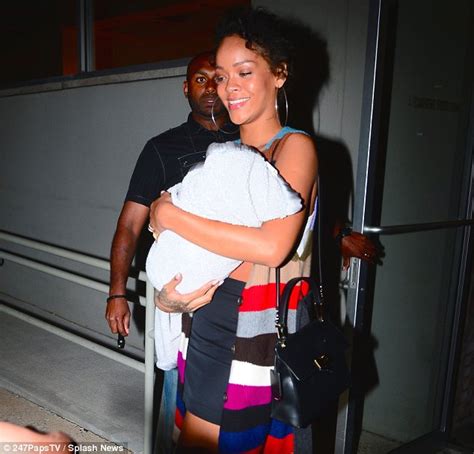 Rihanna Cradles Cousin After Tush Photo Shoot In Nyc Daily Mail Online