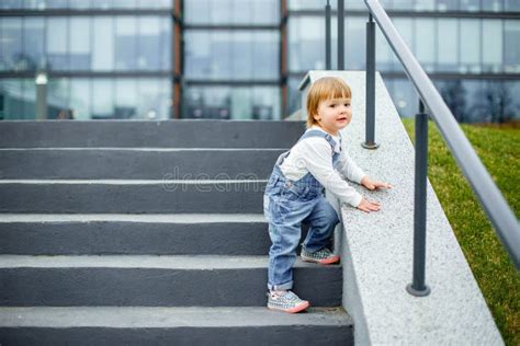 A Small Child Learns To Go Down The Stairs Stock Image Image Of