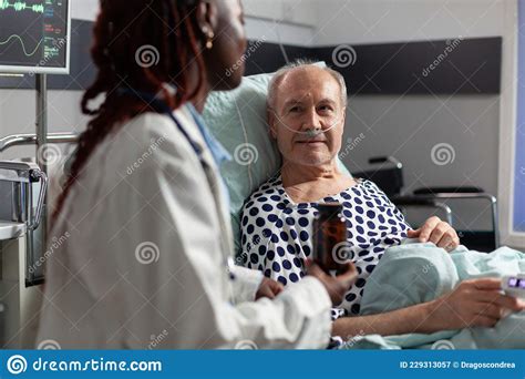 Close Up Of Sick Unwell Senior Man Patient Laying In Hospital Bed
