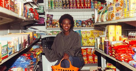 Smiling Black Woman Choosing Goods In Grocery Store · Free Stock Photo