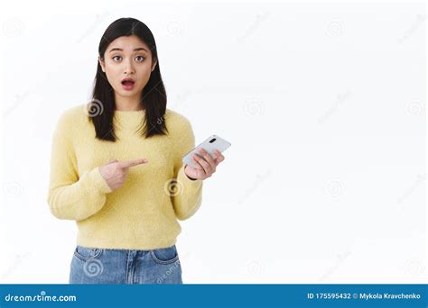 Shocked Speechless Asian Girl Open Mouth And Pointing Mobile Phone
