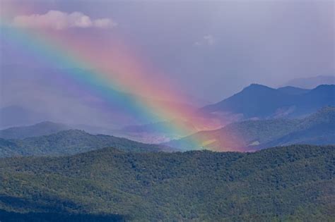 Premium Photo A Beautiful Rainbow Over The Mountain