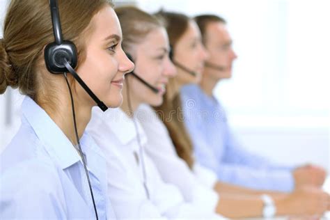 Call Center Operator In Headset While Consulting Client Telemarketing