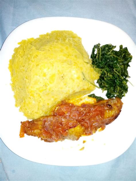 Mash Green Banana Greens And Fried Tilapia With Some Tomatoes Sauce