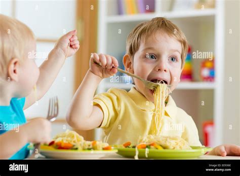 Kids Eating In Kindergarten Stock Photo Alamy