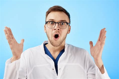 Premium Photo Shocked Doctor In White Coat Opened His Mouth In Surprise Isolated On Blue