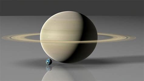Earth Compared To Saturn Photograph By Mark Garlickscience Photo
