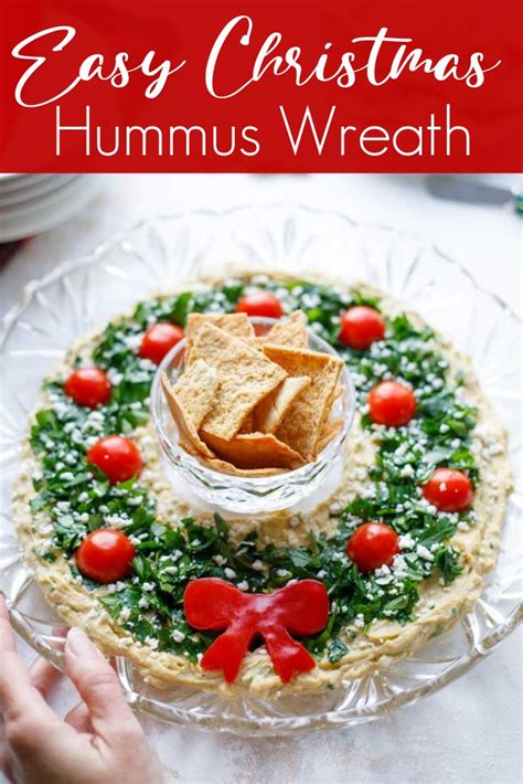 Hummus Appetizer Wreath On A Plate With Crackers And Tomatoes In It