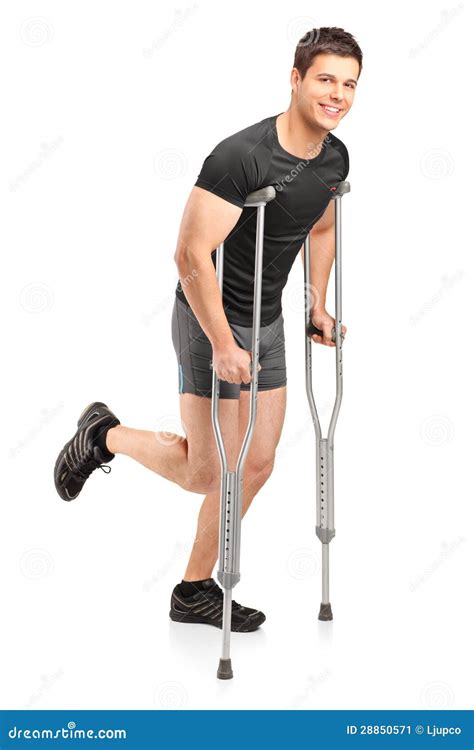 Man Walking With Crutches In Physiotherapy Stock Photo