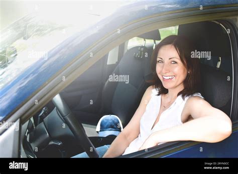 Happy adult woman driving a car and smiling. success happy brunette