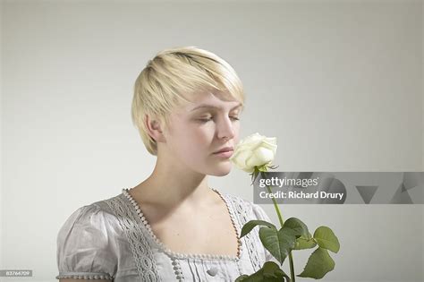 Young Woman Smelling Rose Eyes Closed High Res Stock Photo Getty Images