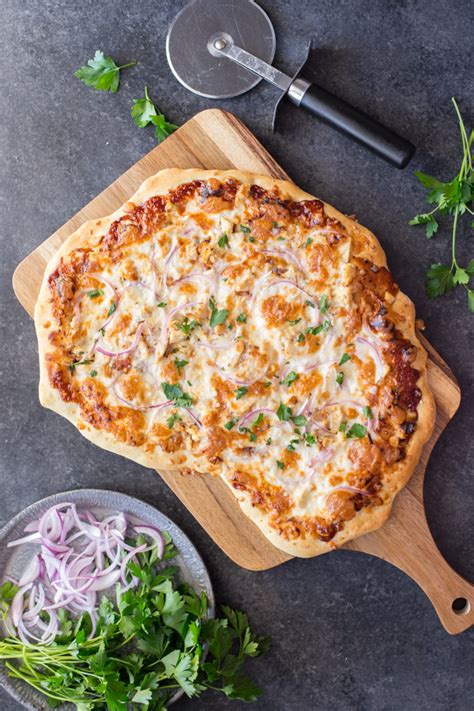 On a lightly floured surface, roll out pizza dough into a large circle, then slide onto prepared baking sheet. Barbecue Chicken Pizza - Lovely Little Kitchen