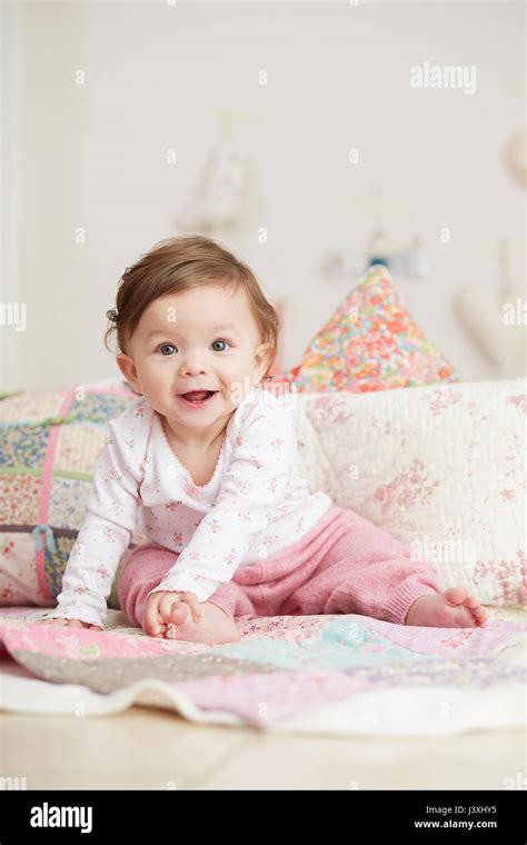 Portrait Of Baby Girl Sitting On Blanket Laughing Stock Photo Alamy