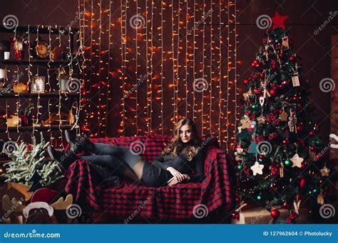 Gorgeous Woman Lying At Sofa Near Decorated Christmas Tree Stock Photo Image Of Cheerful