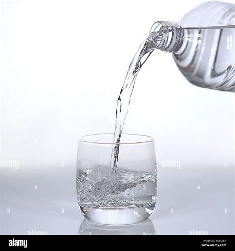Water Being Poured Into Glass Against White Background Stock Photo Alamy