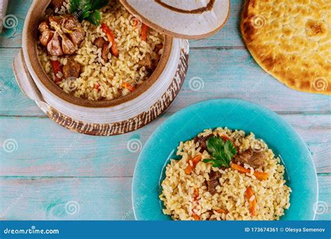 Uzbek Pilaf With Rice Meat Carrot And Garlic In Clay Pot Stock Image