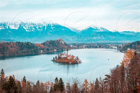 View Of Bled Lake During Autumn With Bled Castle And Snow And Mountains