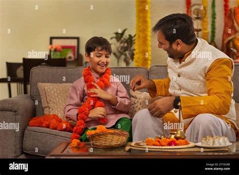 Father And Son Enjoying A Conversation During Ganesh Chaturthi A