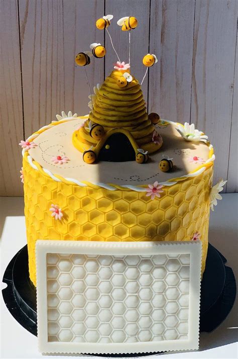 A Cake Decorated With Honeycombs And Bees