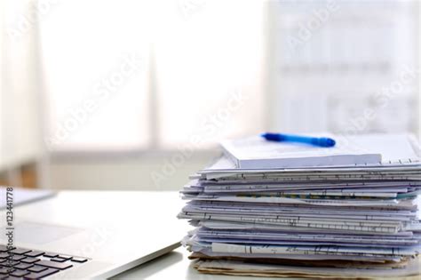 Stack Of Papers On The Desk With Computer Stock Photo And Royalty