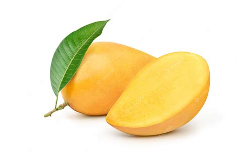 Premium Photo Ripe Yellow Mango With Cut In Half And Green Leaf
