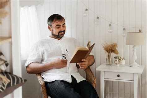 Premium Photo Man Reading Book In Bedroom