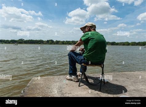 Man Sitting In Chair Fishing Hi Res Stock Photography And Images Alamy