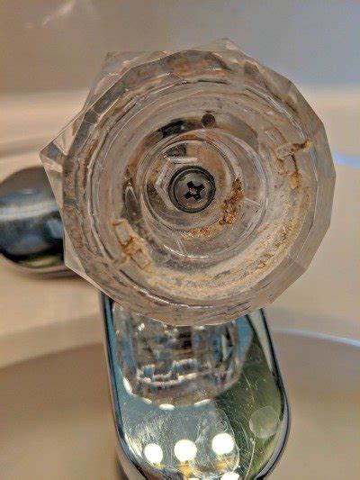 Stuck faucet handle giving you a hard time? How To Clean Bathroom Faucet Handles - Frugally Blonde