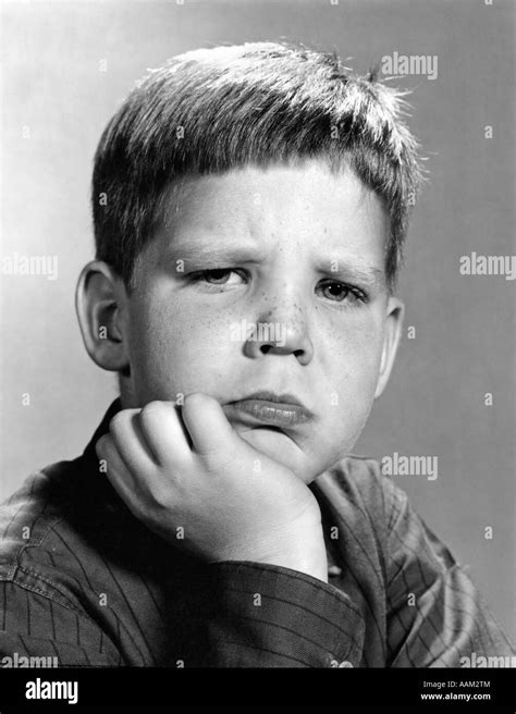 1960s Portrait Pouting Boy Hand To Chin With Angry Sad Serious Facial