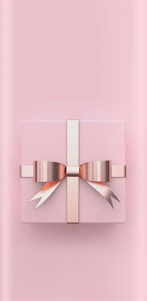 A Pink T Box With A Bow On Its Side Against A Light Pink Background