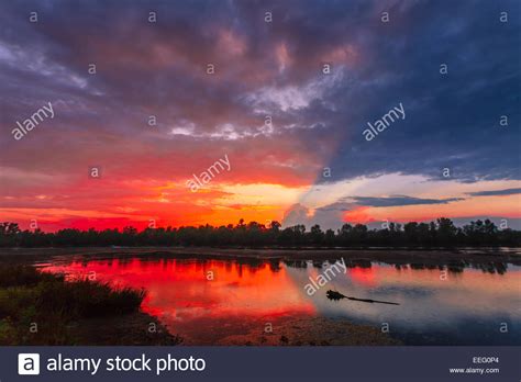 Amazingly Colorful Sunset With Reflective Red Sand And Bright Clouds