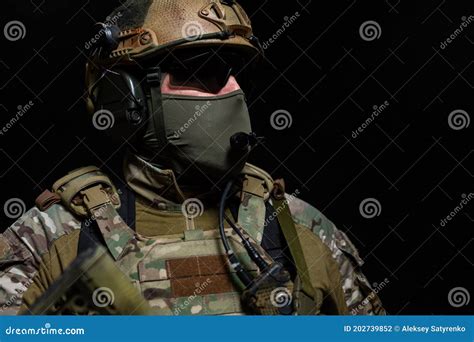 close up portrait of a confident military man standing in a military helmet protective mask and