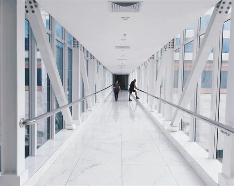 People Walking In The Hallway Inside The Building · Free Stock Photo