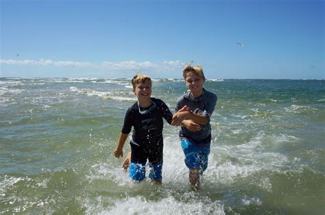 My Sons Julian And Keiran Running Laughing And Splashing In The Ocean