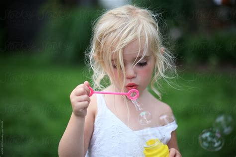 Girl Blowing Bubbles By Stocksy Contributor Alicia Bock Stocksy