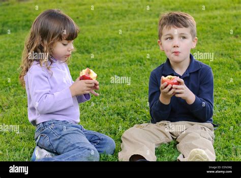 Two Children Eating Apples Stock Photo Alamy